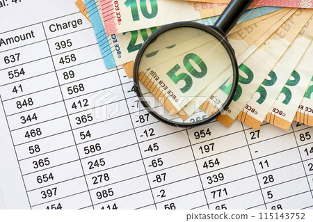 Business and savings concept with many euro money bills and magnifying glass close up Business and savings concept with many euro money bills and magnifying glass close up 115143752