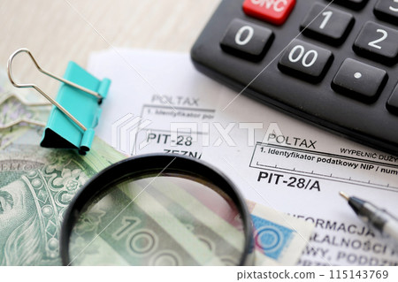 Information of income of inherited enterprise PIT28 and PIT-28A tax forms on accountant table with pen and polish zloty money bills close up Information of income of inherited enterprise PIT28 and PIT-28A tax forms on accountant table with pen and polish zloty money bills close up 115143769