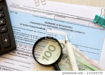 Declaration of the amount of earned income or incurred loss, PIT-38 tax forms on accountant table with pen and polish zloty money bills close up Declaration of the amount of earned income or incurred loss, PIT-38 tax forms on accountant table with pen and polish zloty money bills close up 115143779