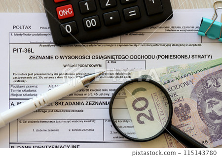 Declaration of the amount of earned income or incurred loss, PIT-36L tax forms on accountant table with pen and polish zloty money bills close up Declaration of the amount of earned income or incurred loss, PIT-36L tax forms on accountant table with pen and polish zloty money bills close up 115143780