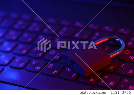 Computer security concept with a closed padlock on the keyboard. Padlock on top of a laptop keyboard. Selective focus Toned image 115143790