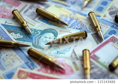 Many bullets and iranian rials money bills close up. Concept of terrorism funding or financial operations to support war in Iran 115143888