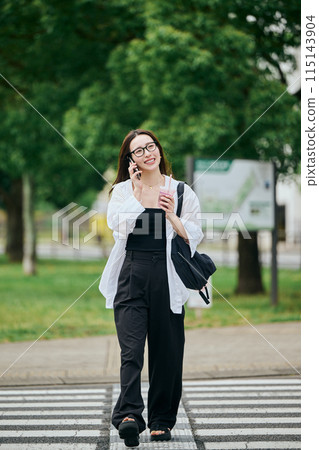 A young lady crossing a crosswalk 115143904
