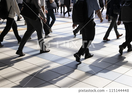 Back view of businessmen commuting to work in Tokyo in the morning Back view of businessmen commuting to work in Tokyo in the morning 115144448