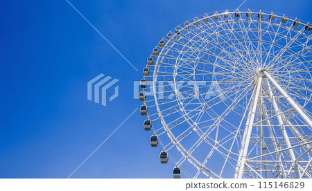 white big Ferris wheel on background a bright blue sky in amusement park at fair in summer with copy space 115146829