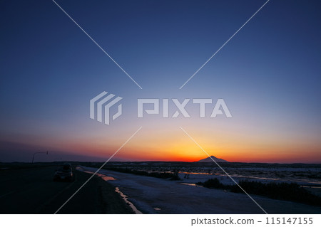 View of the sun setting south of Mount Rishiri from Hokkaido Route 444 in early spring 115147155