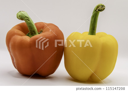 Two peppers. Red pepper and yellow pepper on white background Two peppers. Red pepper and yellow pepper on white background 115147208