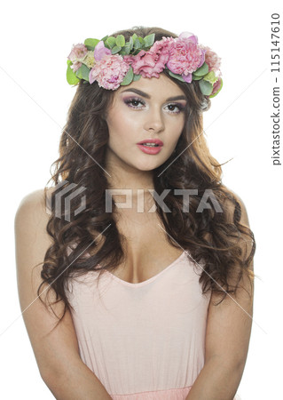 Fashionable brunette woman with fresh flower on her head. Spring, cosmetic 115147610