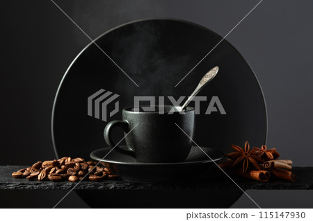 Cup of black coffee with coffee beans, cinnamon and anise. 115147930