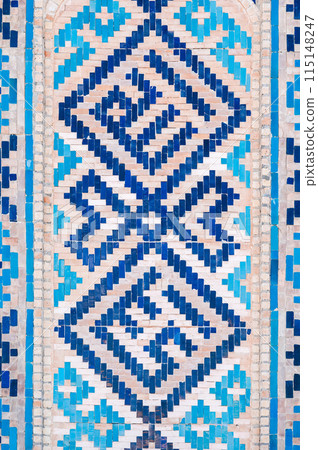 ancient ceramic tile with a traditional oriental pattern Uzbek ornament decorates the wall of old islamic Barakhan Madrasah in Tashkent 115148247