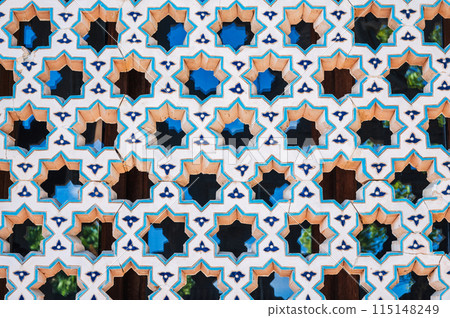 ancient lattice of ceramic tiles with star pattern on window of the old Islamic mosque Hazrati Imam in Uzbekistan ancient lattice of ceramic tiles with star pattern on window of the old Islamic mosque Hazrati Imam in Uzbekistan 115148249