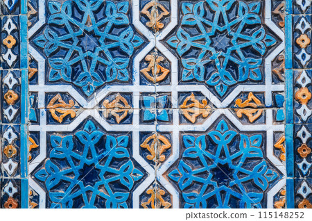ancient ceramic tile with traditional Arabic pattern Uzbek ornament decorates the wall of islamic Hazrati Imam mosque in Tashkent in Uzbekistan 115148252