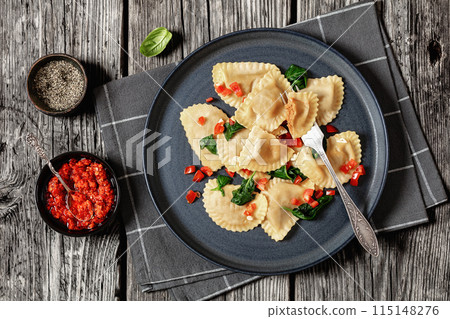 italian pasta mezzelune on a plate, top view 115148276