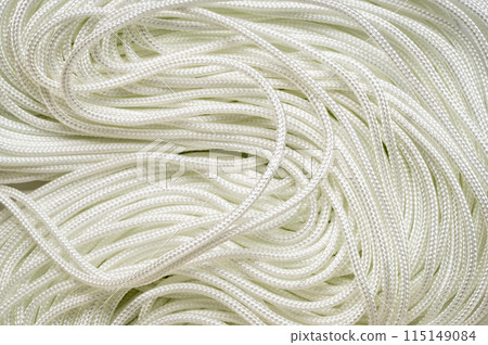 coils of white thin paracord background 115149084