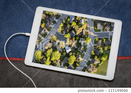 spring sunrise over residential area of Fort Collins in Colorado, reviewing an aerial image on a tablet spring sunrise over residential area of Fort Collins in Colorado, reviewing an aerial image on a tablet 115149086