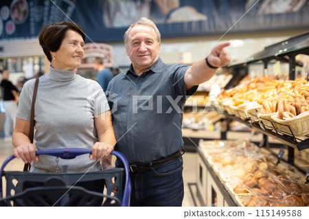 Couple chooses sweet puffs in bakery 115149588