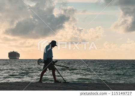 A Man with metal detector at Miami Beach, Miami, Florida, USA A Man with metal detector at Miami Beach, Miami, Florida, USA 115149727