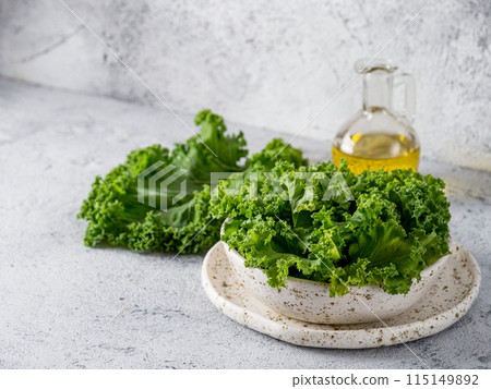 Kale leaves in bowl, copy space left Kale leaves in bowl, copy space left 115149892
