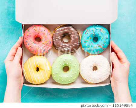 hands holding box with donuts hands holding box with donuts 115149894