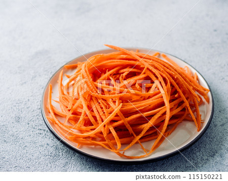 Raw carrot noodles or spaghetti, top view Raw carrot noodles or spaghetti, top view 115150221