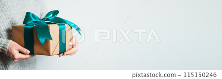 Female hands hold gift box, copy space right Female hands hold gift box, copy space right 115150246