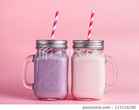 Strawberry and blueberry smoothie on pink Strawberry and blueberry smoothie on pink 115150290
