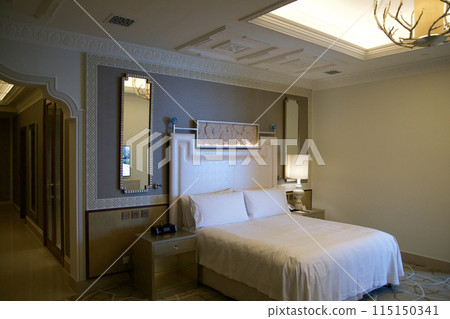 RAS AL KHAIMAH, UNITED ARAB EMIRATES - JUN 11, 2019: King-size bed in a luxurious hotel room in a five star hotel 115150341