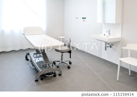 A doctor's office with a couch and a chair to examine a patient's health 115150414
