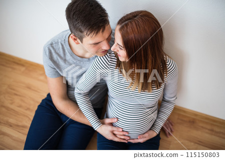 Pregnant woman and her partner, touching her belly. Pregnant woman and her partner, touching her belly. 115150803