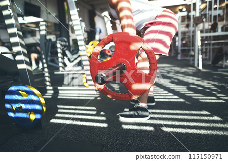 Strong man performing deadlift with barbell. Routine workout for physical and mental health. 115150971