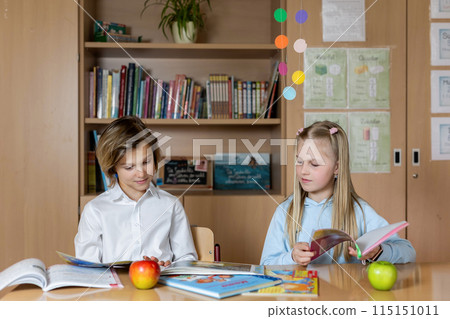 Portrait of two cute caucasian young blond little classmate friend kids eating apple in classroom at lunch time pause. Schoolchildren friendship. Healthy snack food. Back to school concept Portrait of two cute caucasian young blond little classmate friend kids eating apple in classroom at lunch time pause. Schoolchildren friendship. Healthy snack food. Back to school concept 115151011