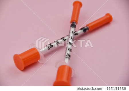 Insulin Syringe for diabetes on pink background, health care concept. A pink background featuring an insulin syringe, symbolizing diabetes management and the importance of healthcare 115151586