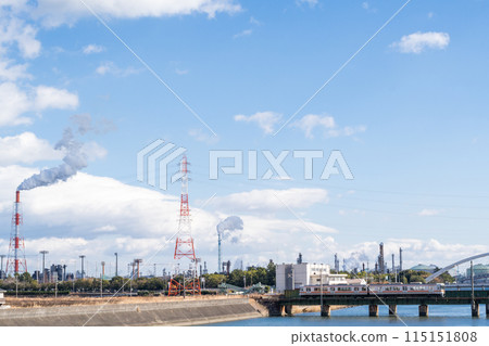 [Kansai Main Line] A local train passing through a factory area 115151808