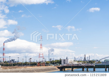 [Kansai Main Line] A local train passing through a factory area 115151809