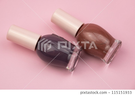 Nail polish small glass bottles on pink background, professional manicure concept 115151933