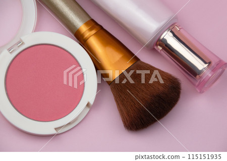 Coral blush, fuchsia eyeshadows and makeup brush on pink background, cosmetics texture 115151935
