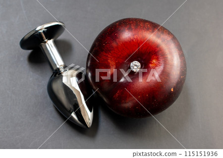 Anal sex concept, anal plug on a black background, butt plug with blue rhinestone, sex toy Anal sex concept, anal plug on a black background, butt plug with blue rhinestone, sex toy 115151936