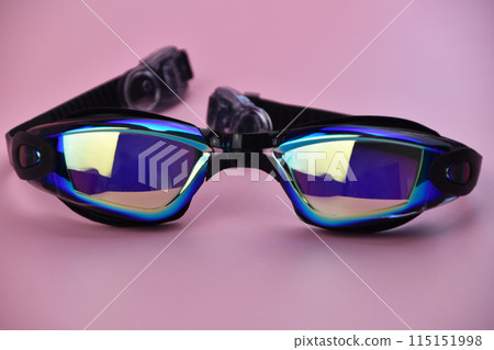 Swimming goggles on pink background Swimming goggles on pink background 115151998