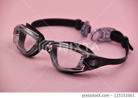 Swimming goggles on pink background 115152001