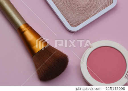 Coral blush, fuchsia eyeshadows and makeup brush on pink background, cosmetics texture Coral blush, fuchsia eyeshadows and makeup brush on pink background, cosmetics texture 115152008