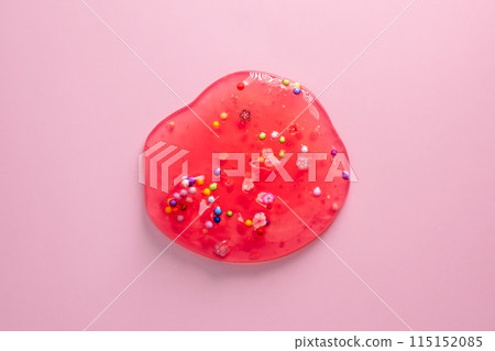 Colorful gel texture, clear skincare cream with bubbles and decorative figurines background, transparent beauty serum, colored cosmetic product close up 115152085