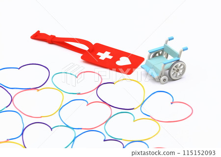 Image of a help mark, wheelchair and rubber band 115152093