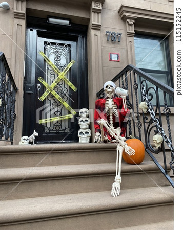 A human skeleton on the porch, Halloween house decoration. Halloween decoration in New York City, United States of America A human skeleton on the porch, Halloween house decoration. Halloween decoration in New York City, United States of America 115152245