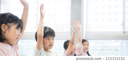 Elementary school students taking classes, banner with hand raised and saying "yes" 115153152