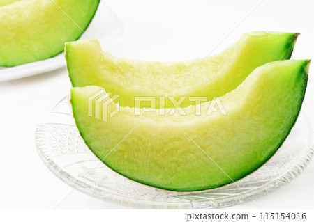 Cut melon on a plate 115154016