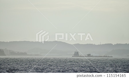 A cargo ship sailing through Tokyo Bay and the Miura Peninsula A cargo ship sailing through Tokyo Bay and the Miura Peninsula 115154165