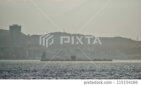 A cargo ship sailing through Tokyo Bay and the Miura Peninsula A cargo ship sailing through Tokyo Bay and the Miura Peninsula 115154166