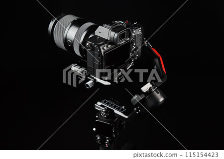Camera mounted on electronic gimbal in studio lighting 115154423