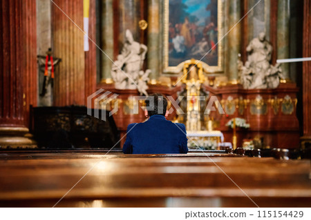 Back View of Man Praying in Catholic Church Back View of Man Praying in Catholic Church 115154429