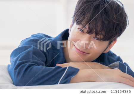 Man smiling in bed Man smiling in bed 115154586